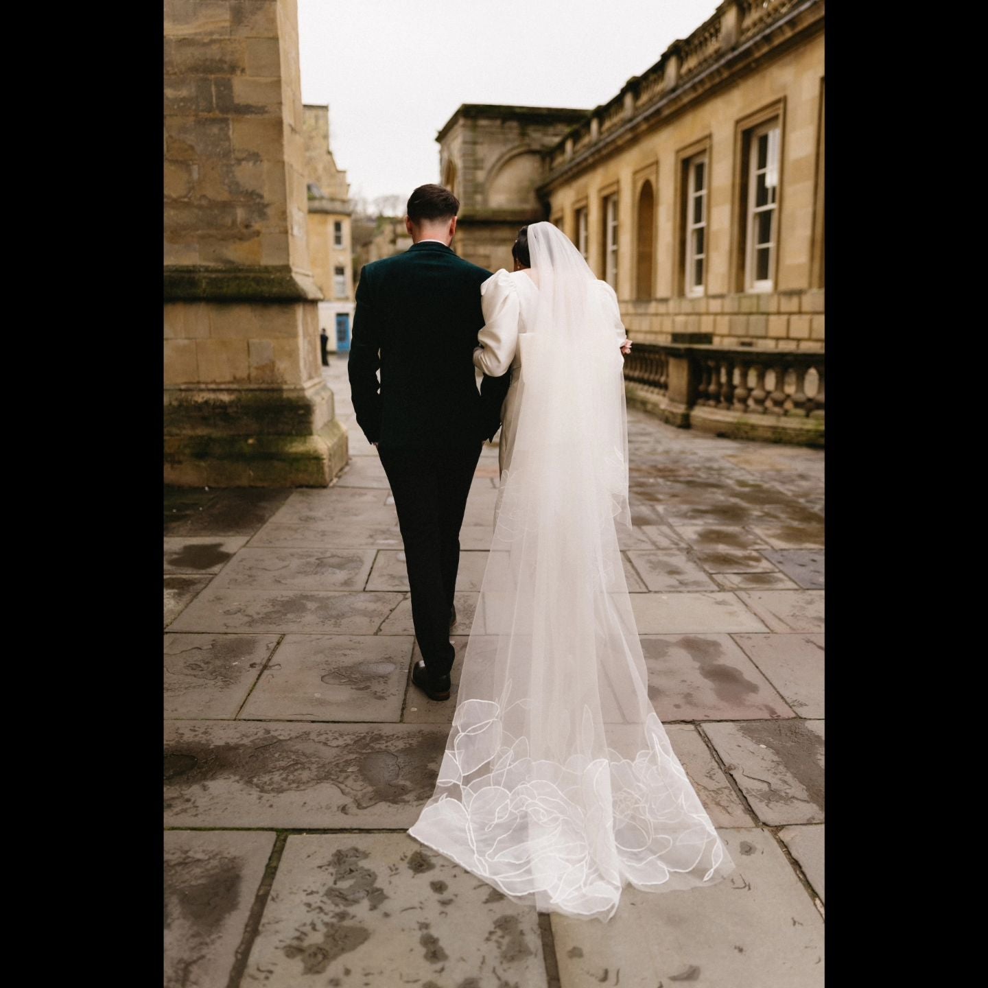 A bride and groom walking down the street