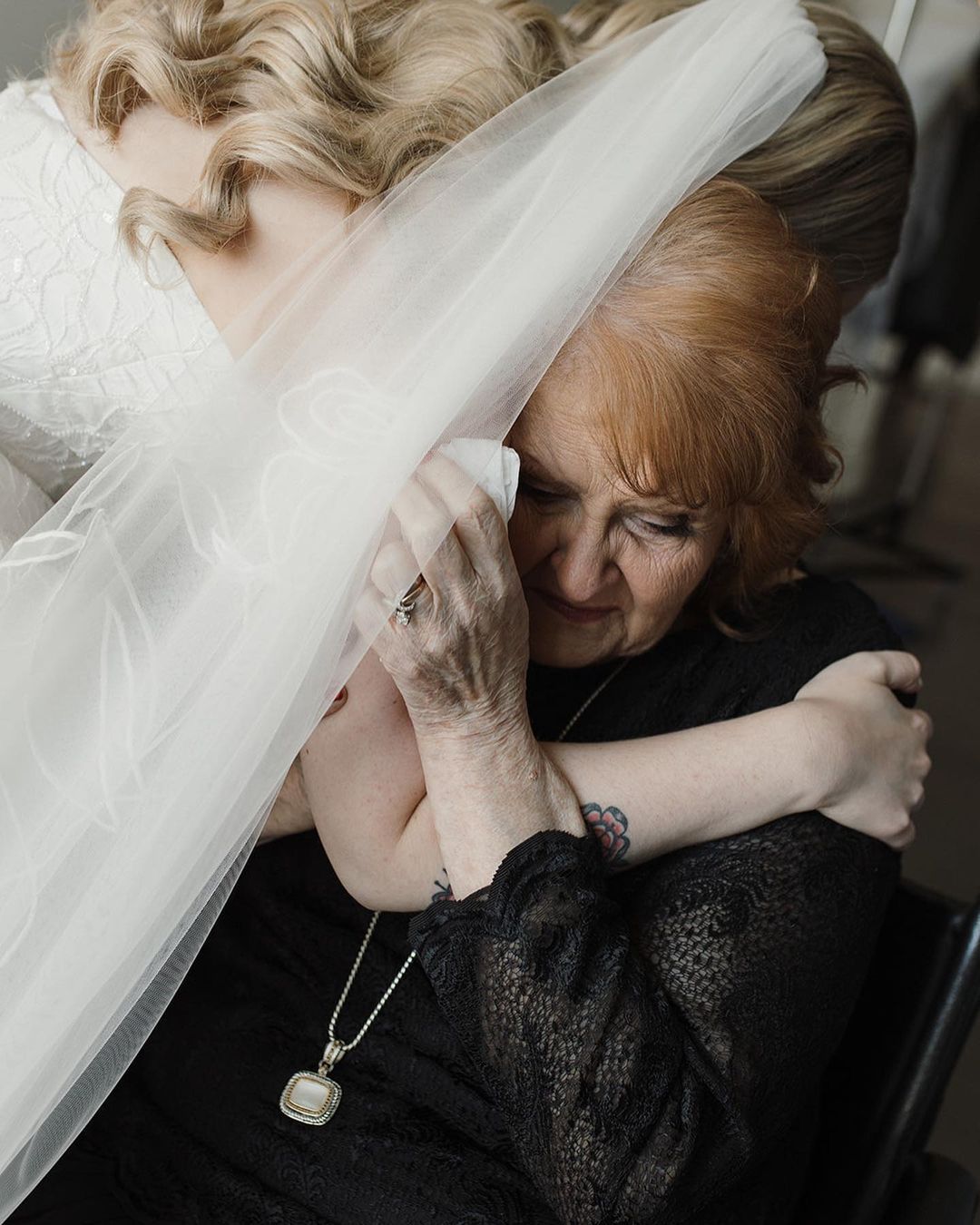 woman in a wedding dress hugging another woman
