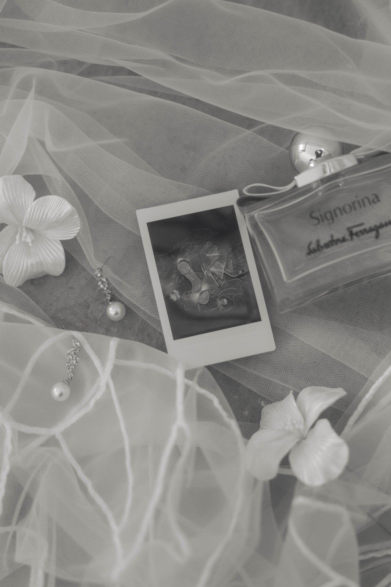 A picture of a necklace and a bottle of perfume