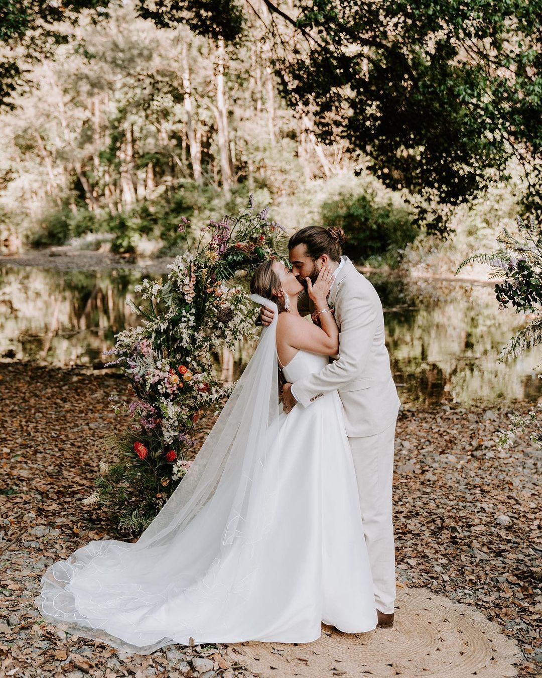 Wedding photographer in Sydney capturing a beautiful outdoor ceremony with vibrant flowers and happy couples.