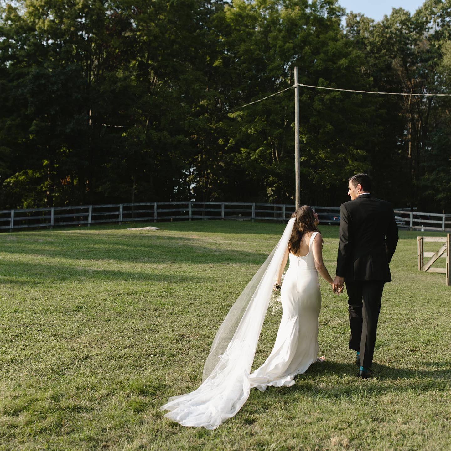 Couple in a yard wearing wedding dress