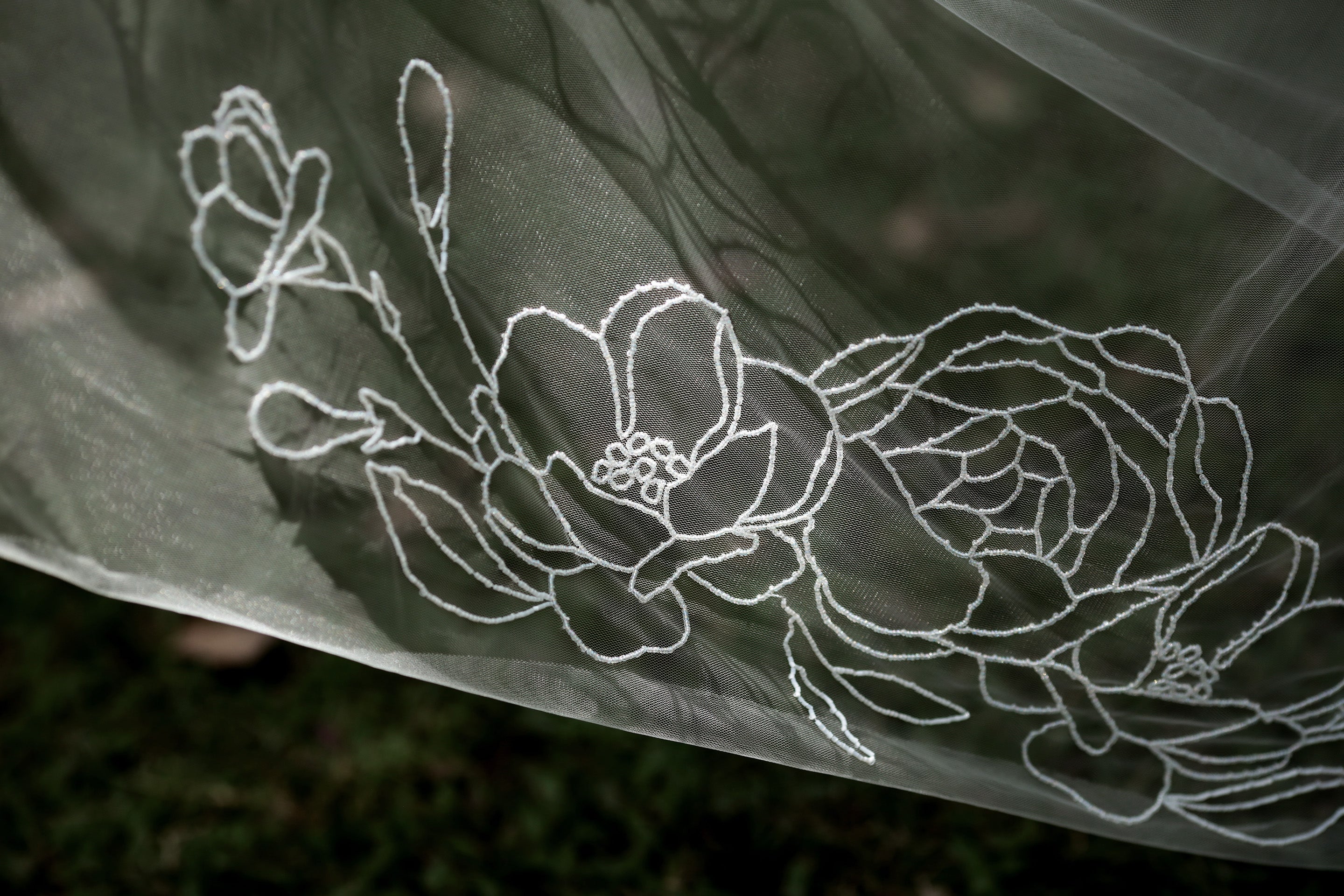 The Cassandra veil, a beaded floral wedding accessory.

