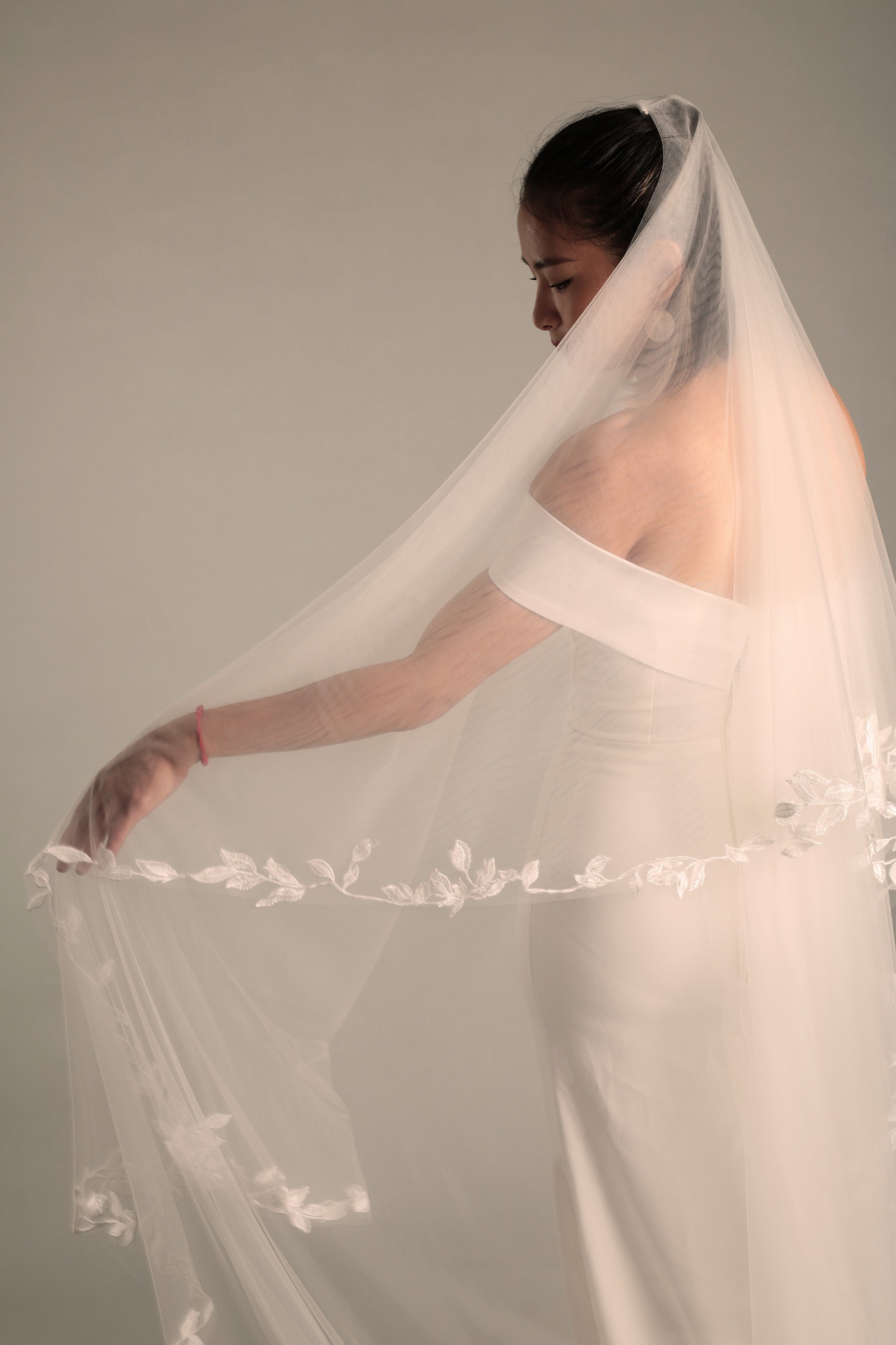 The left side of the BRITTNIE wedding veil, featuring the beautiful floral lace and a hint of the sheer blusher.

