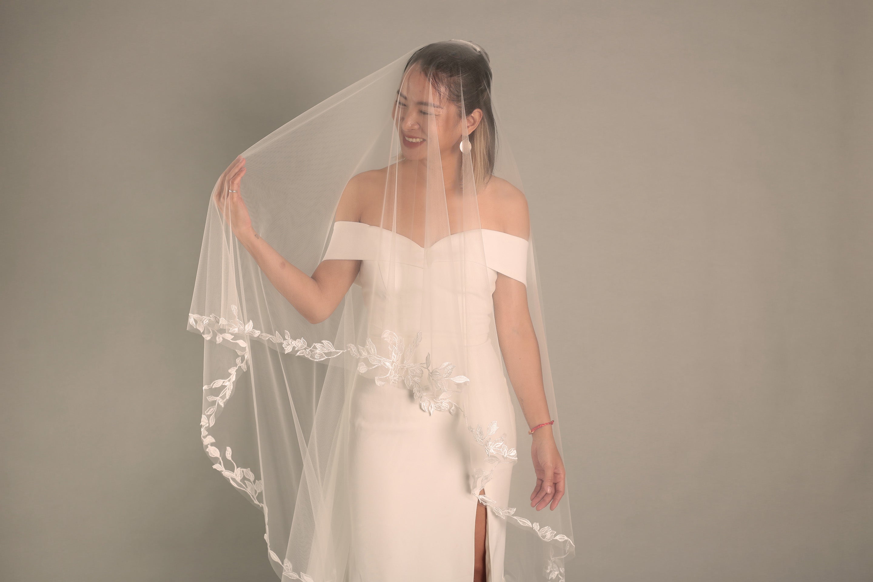 Front view of the BRITTNIE veil, showing the sheer blusher framing the bride's face

