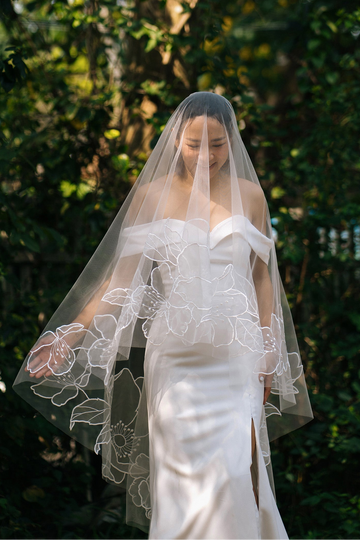 Organza fingertip length wedding veil with blooming floral motifs, handcrafted by Tara Bridal