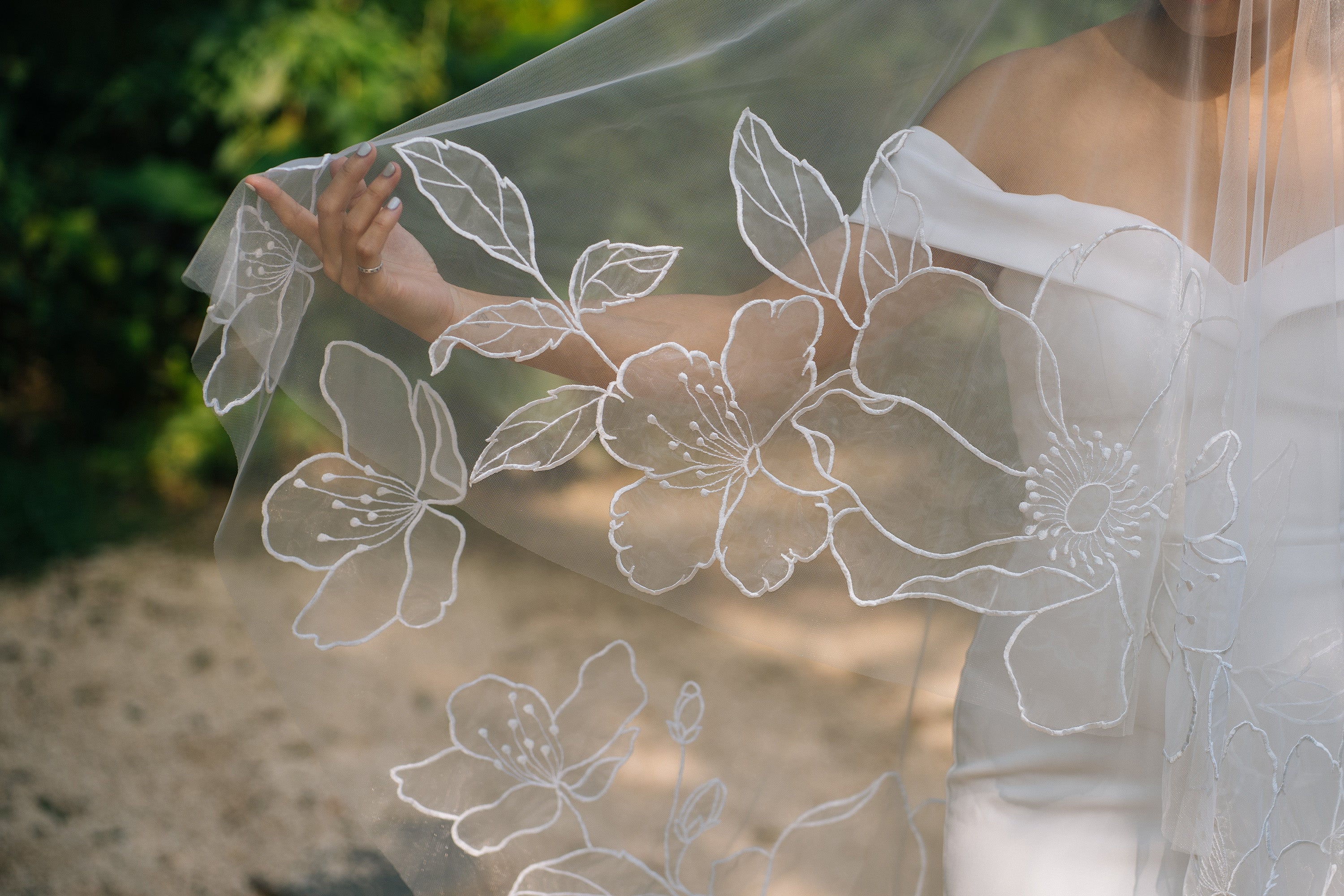 Organza fingertip length wedding veil with blooming floral motifs, handcrafted by Tara Bridal, suitable for garden, outdoor, natural wedding theme
