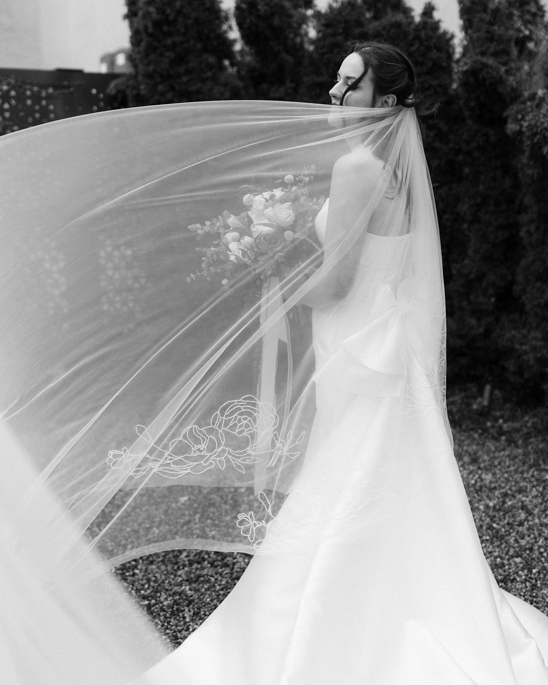 Bride Anna Dietrich with a roses and peonies beaded embroidery royal cathedral 130 inch length wedding veil flowing in the wind outdoor