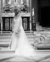Bride wearing cathedral-length floral wedding veil with a blusher and floral crown in a traditional church wedding