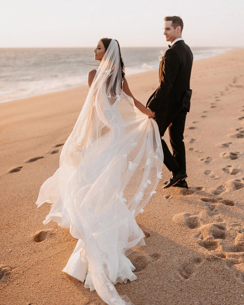 Beach wedding with floral 3d dreamy veil flowing gracefully in the wind