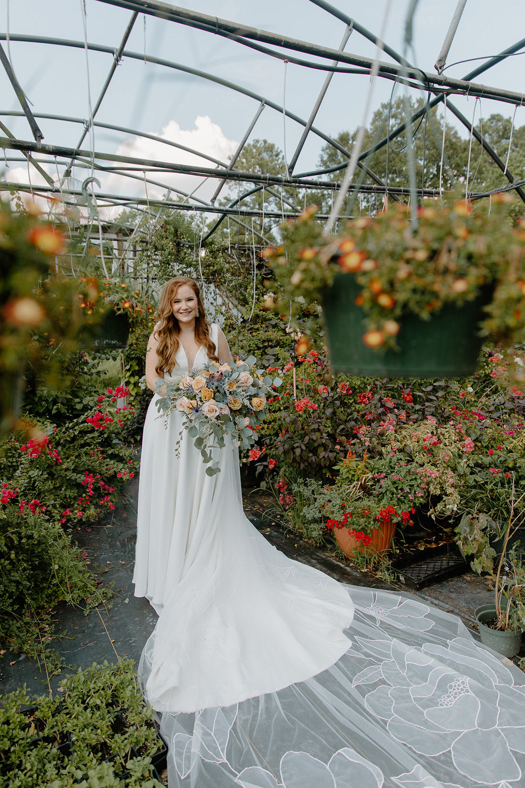 Bride Madeline Ringwald floral cape Kaitie veil in a garden
