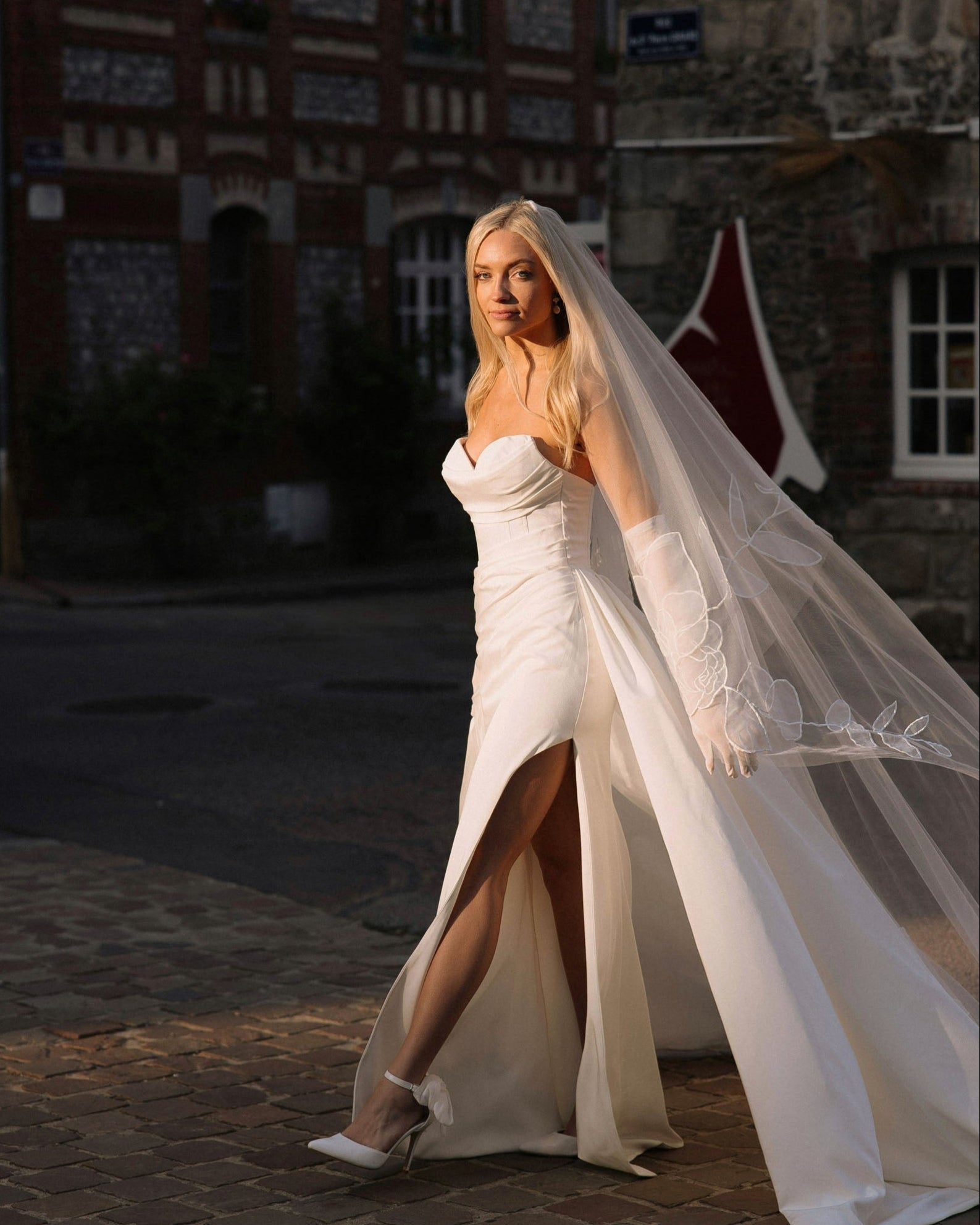Bride Michelle Teachout wearing a floral rose wedding veil in a France village