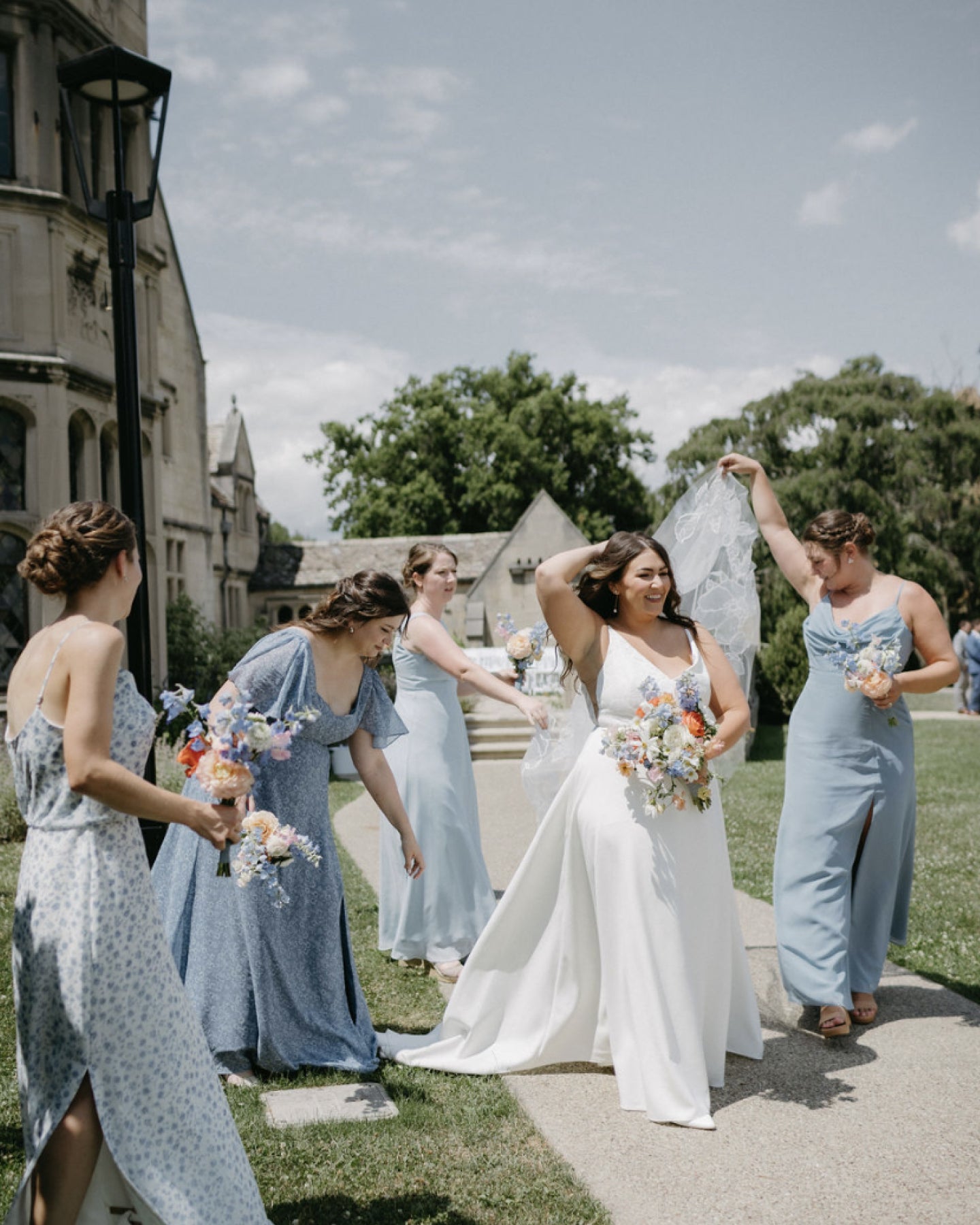 A group of women standing next to each other in front of a building