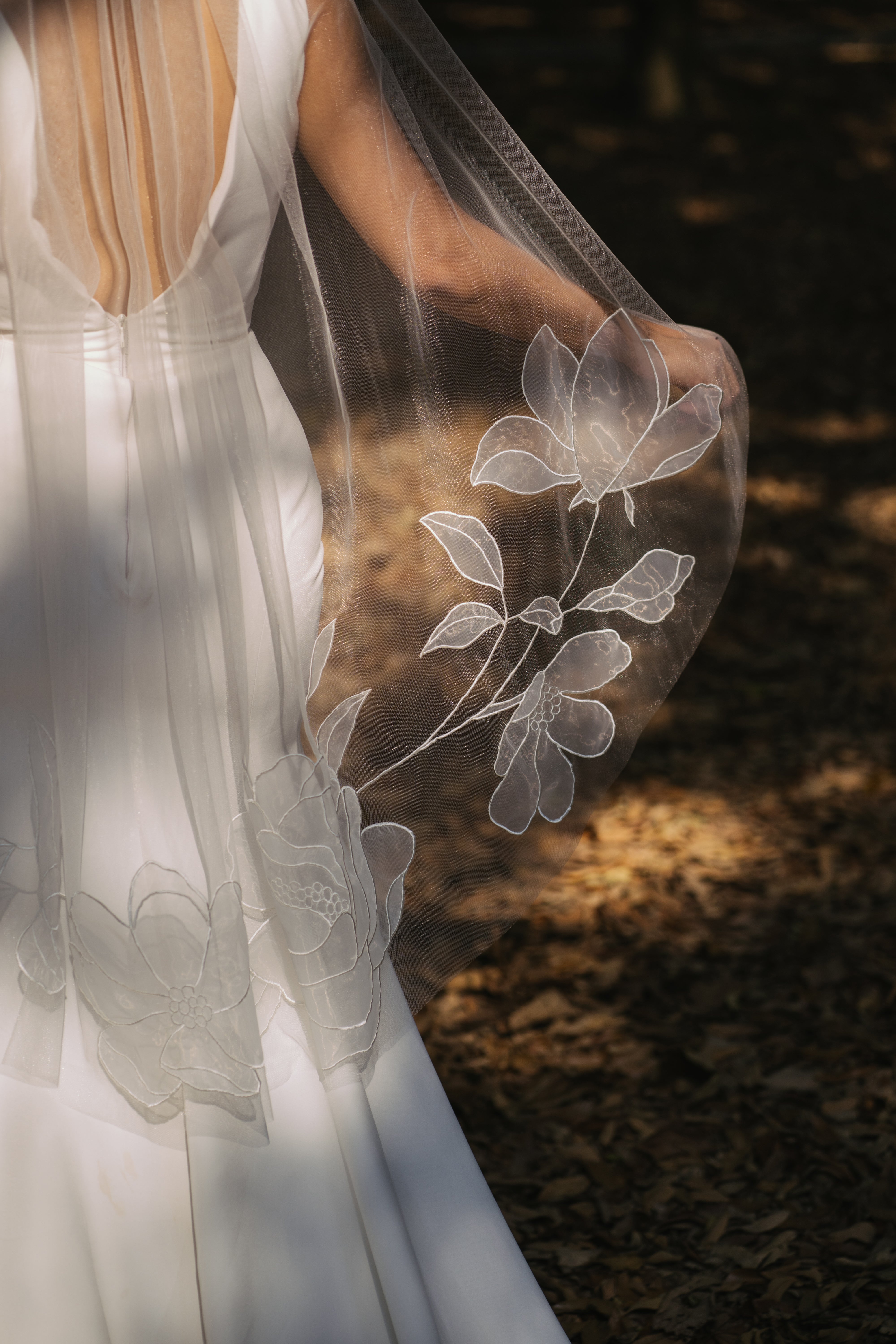Kaitie fingertip length wedding veil with embroidered peony and cosmos flowers, tulle and organza fabric