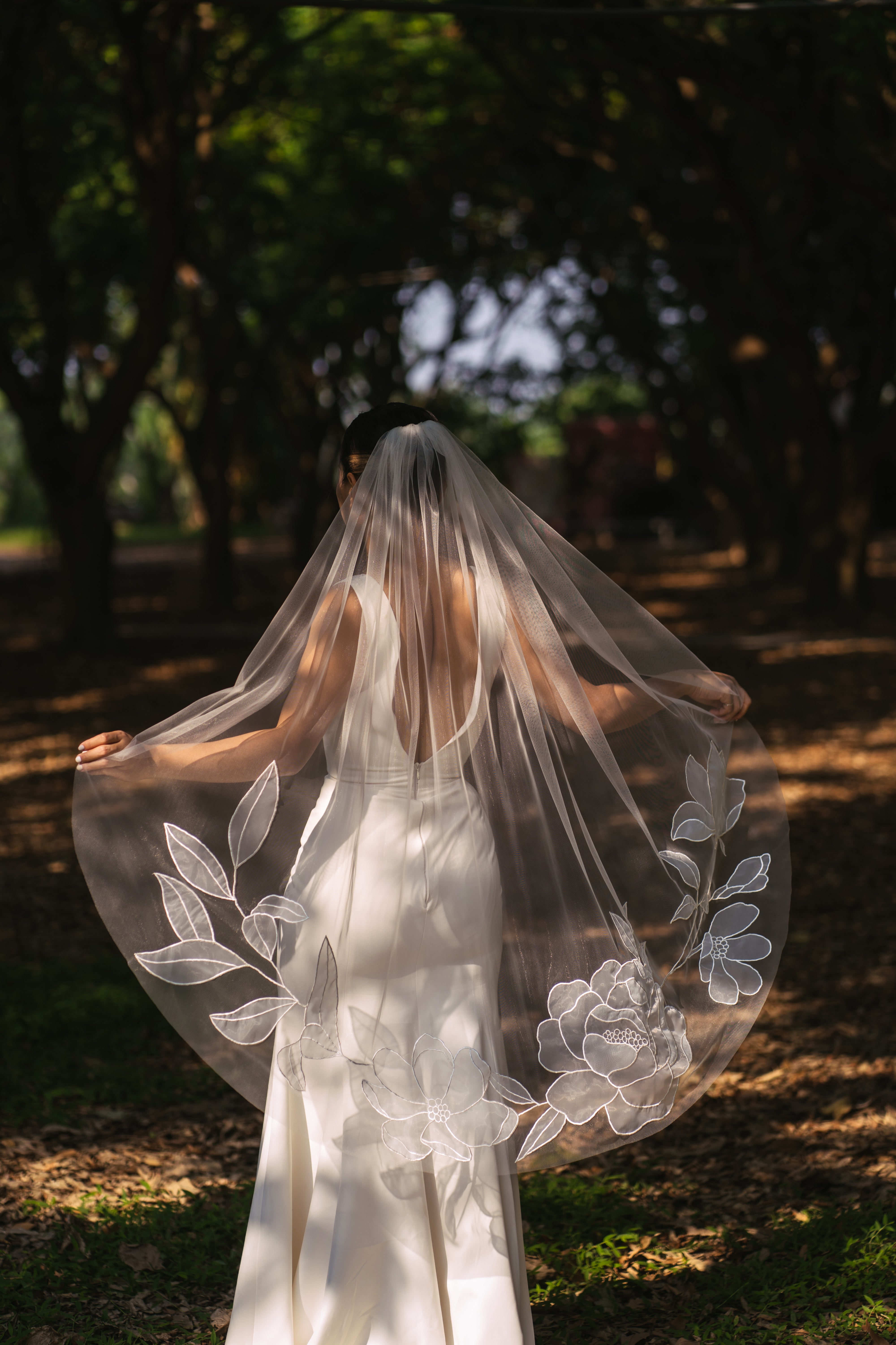 Kaitie fingertip length wedding veil with embroidered peony and cosmos flowers, tulle and organza fabric
