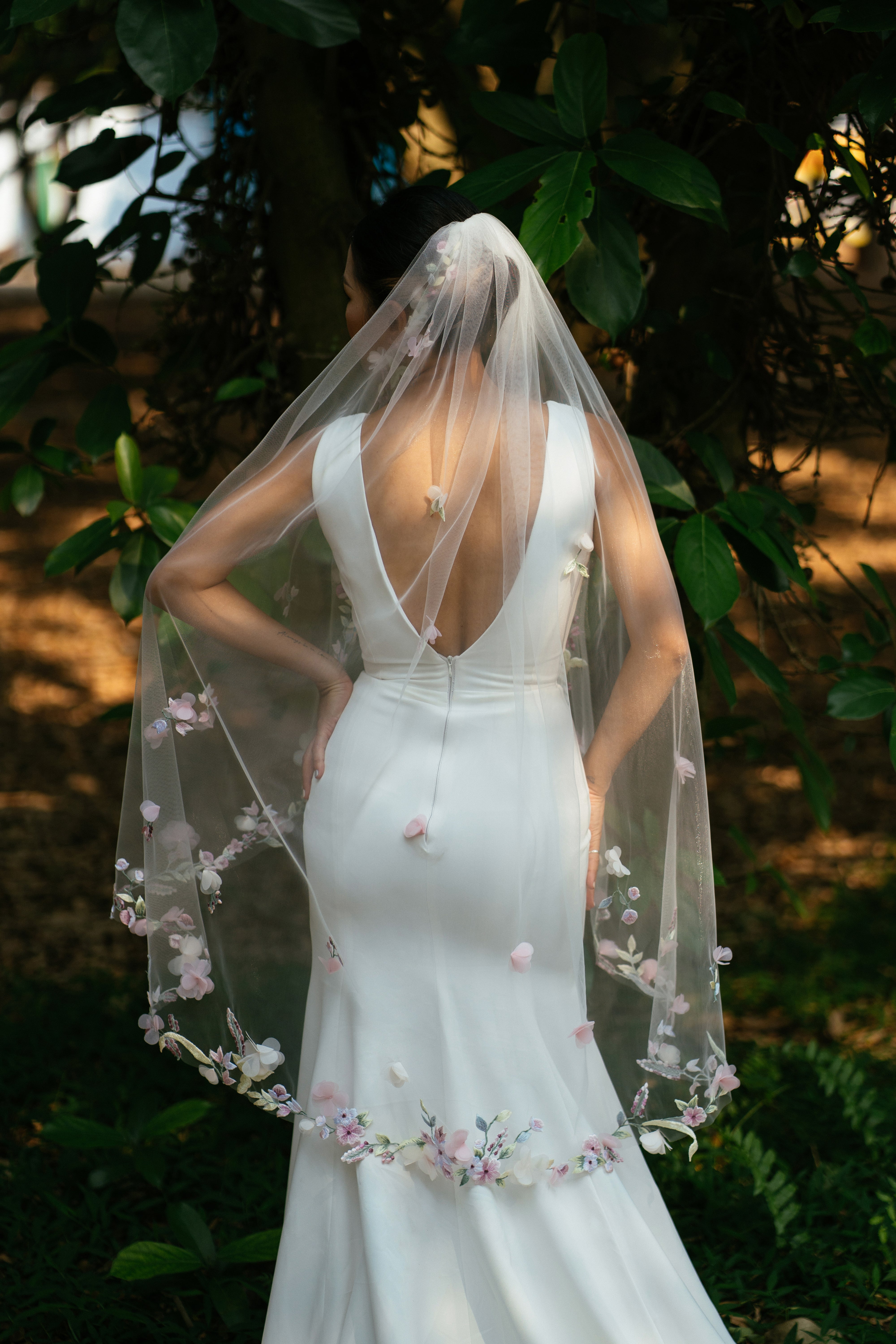 a bride wearing ISABEIL | 3D Colorful Fingertips Wedding Veil from behind 