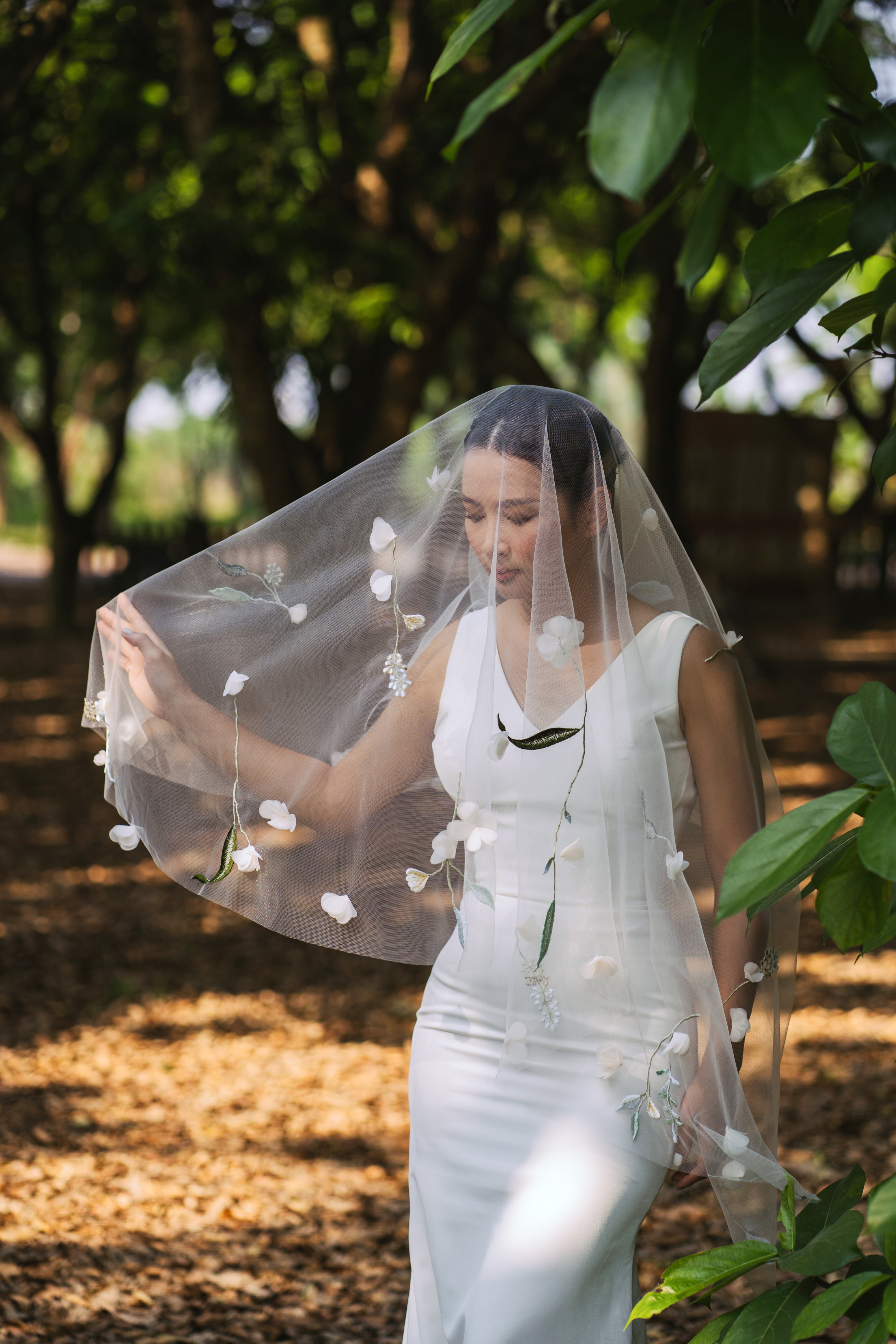 The "SERA" wedding veil, designed to be fingertip-length and covered in cheerful, colorful 3D florals.