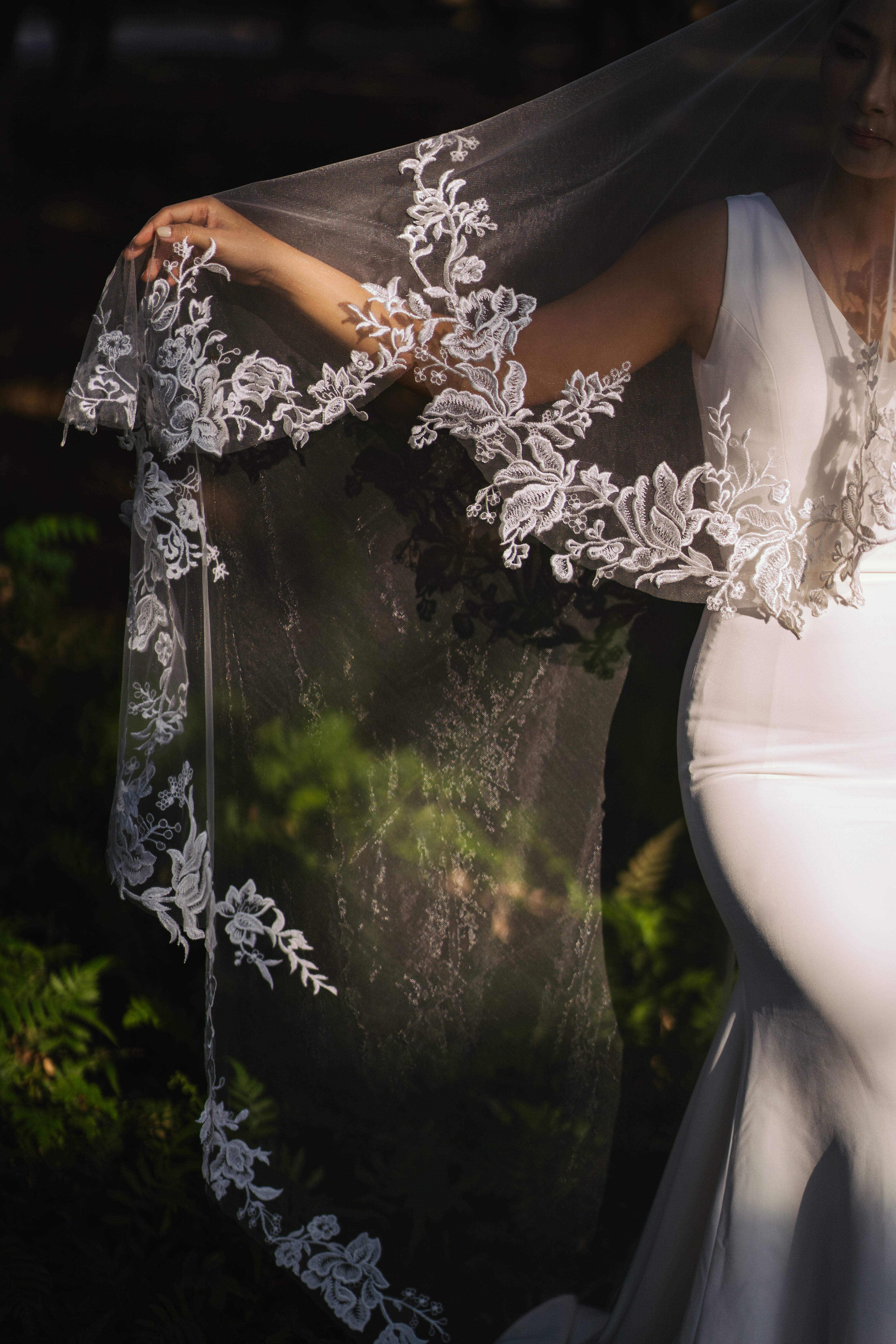 front view of Detailed view of the elegant lace embroidery on the "ELA" veil.