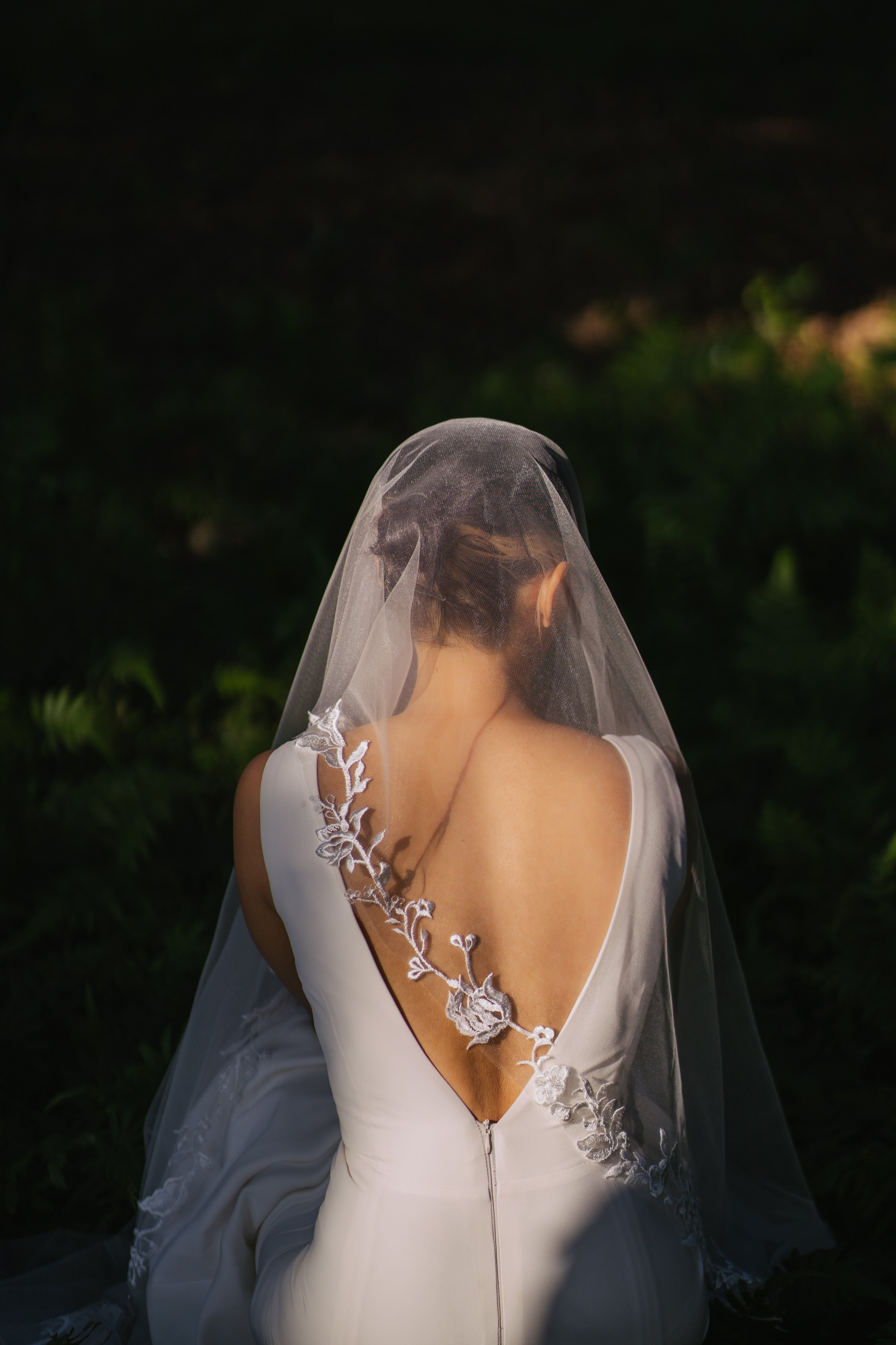a  bride wearing ELA lace wedding veil from behind 