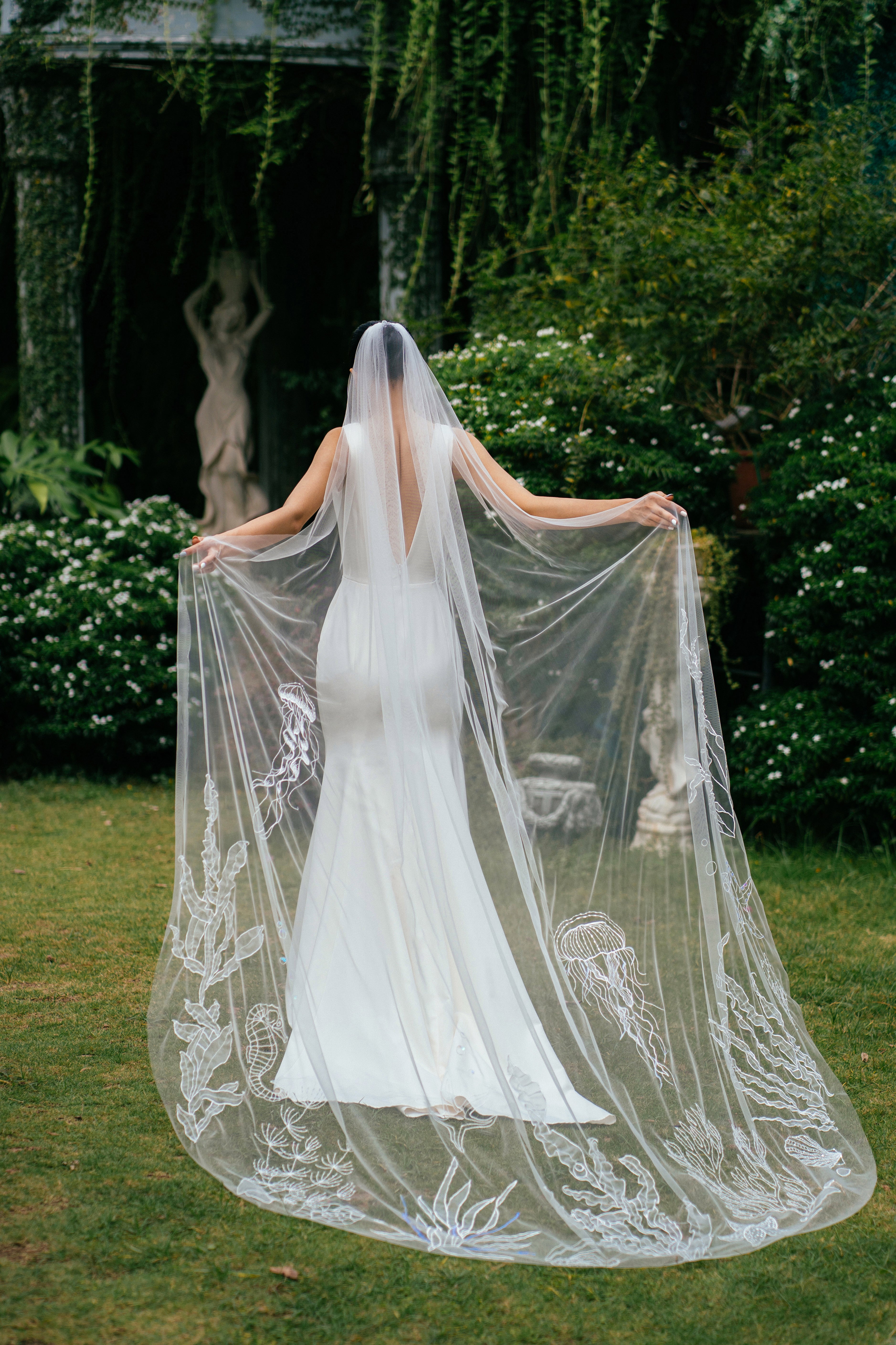 a bride wearing OCEAN Veil | 3D embroidered wedding veil, shot from behind 
