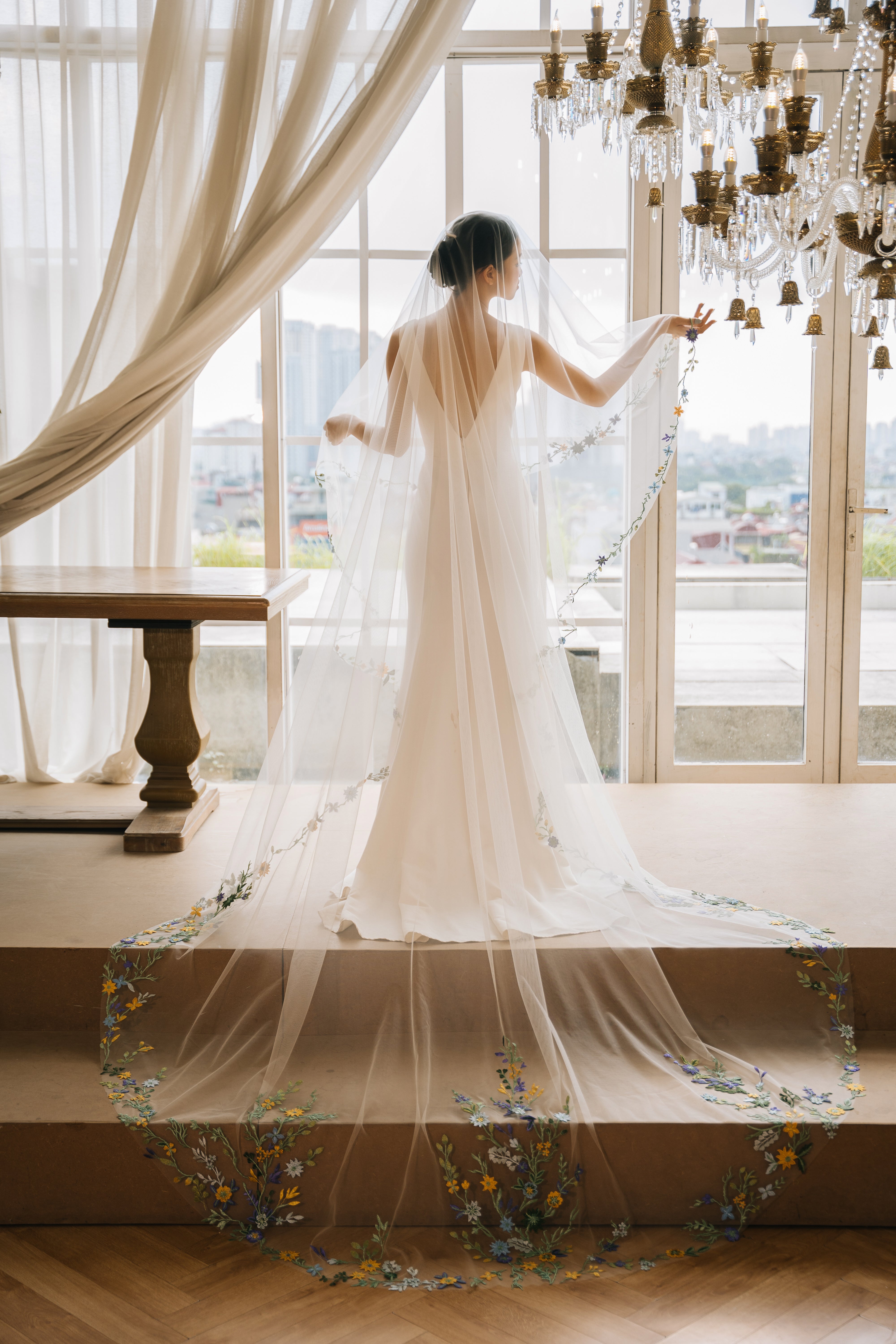a bride wearing Handcrafted Lace Floral Wedding Veil - The Ami Veil from behind 