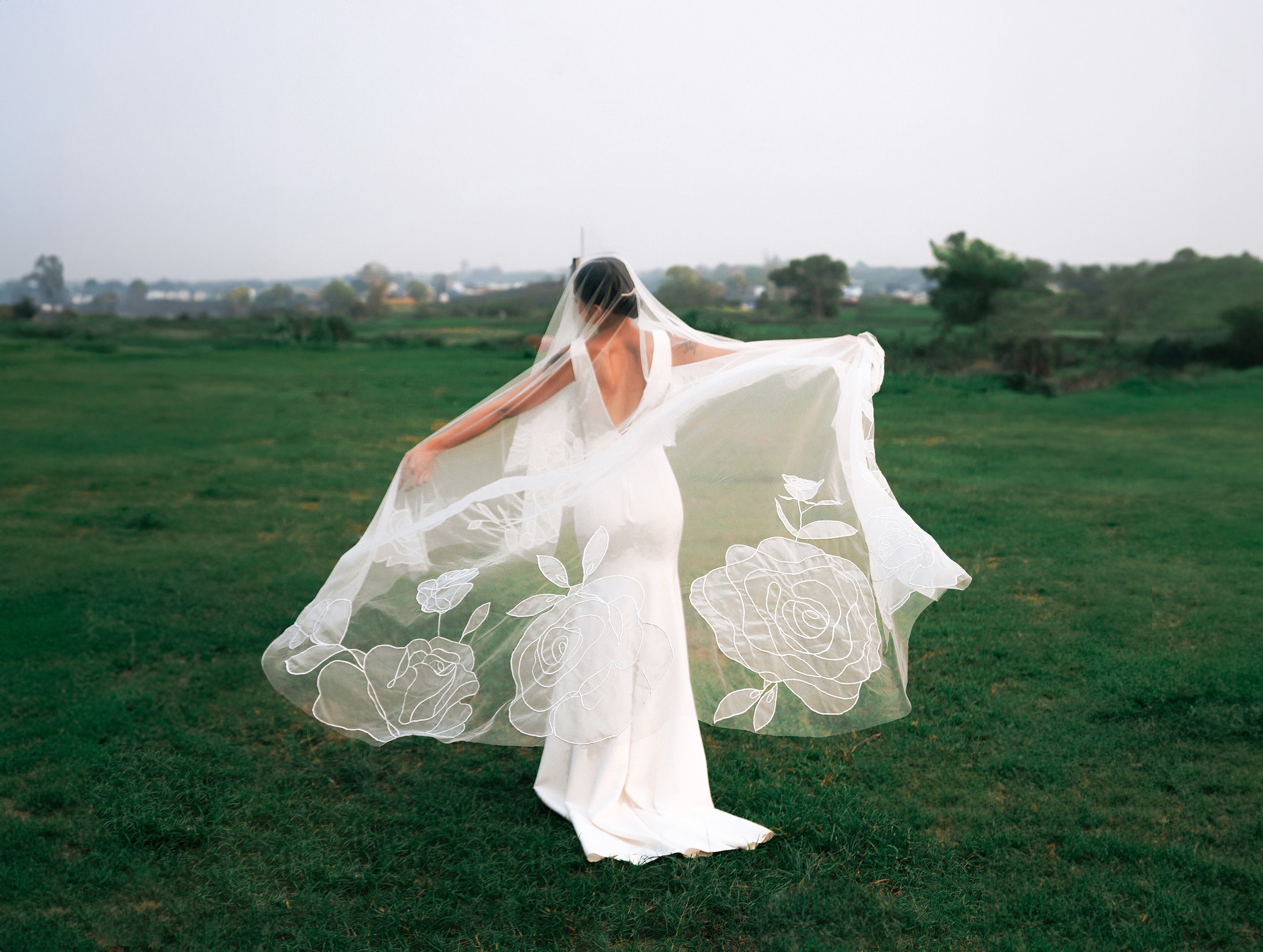 a romantic shot of bride wearing CHARLOTTE | Cathedral organza wedding veil