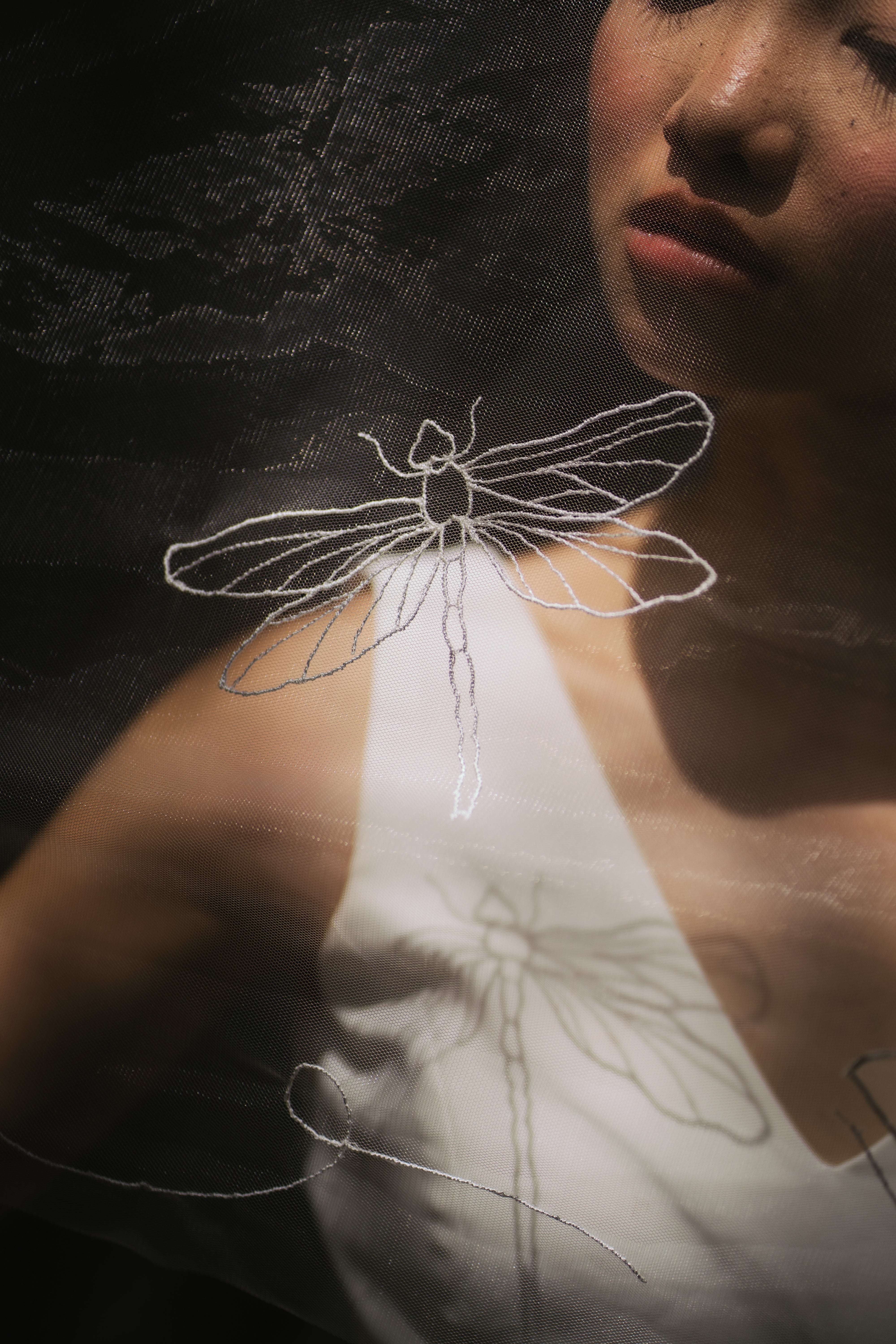 close up shot of a bride wearing SEN | Lotus organza embroidered wedding veil