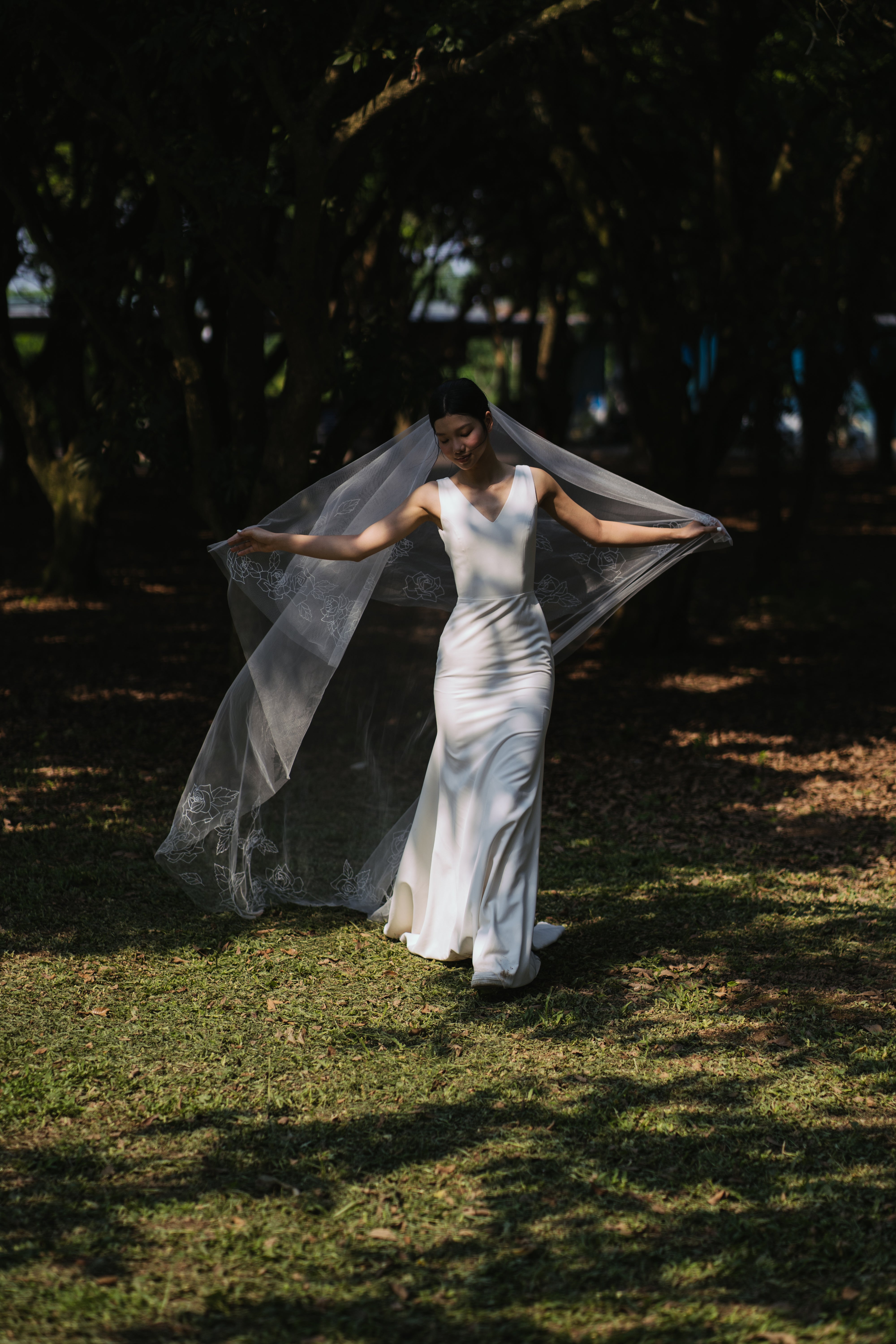 Full shot of the CHLOE embroidered veil, featuring a cascading floral design with roses.

