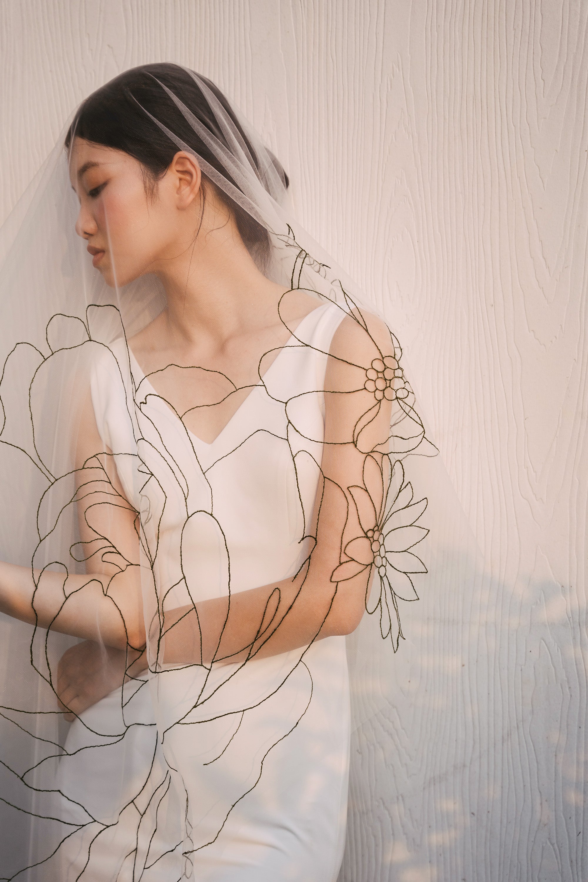 beautiful picture of bride wearing EMMA Veil | Dark green line floral embroidered veil