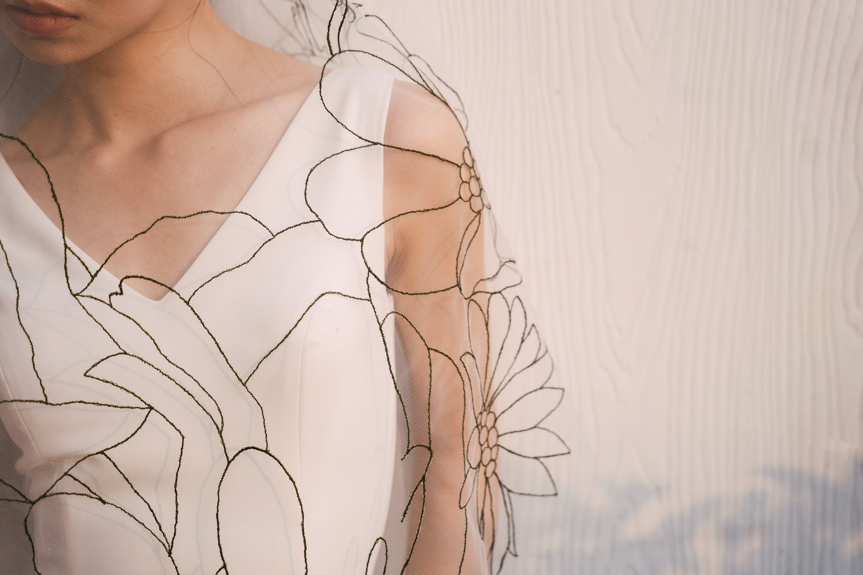 close up shot of EMMA Veil | Dark green line floral embroidered veil