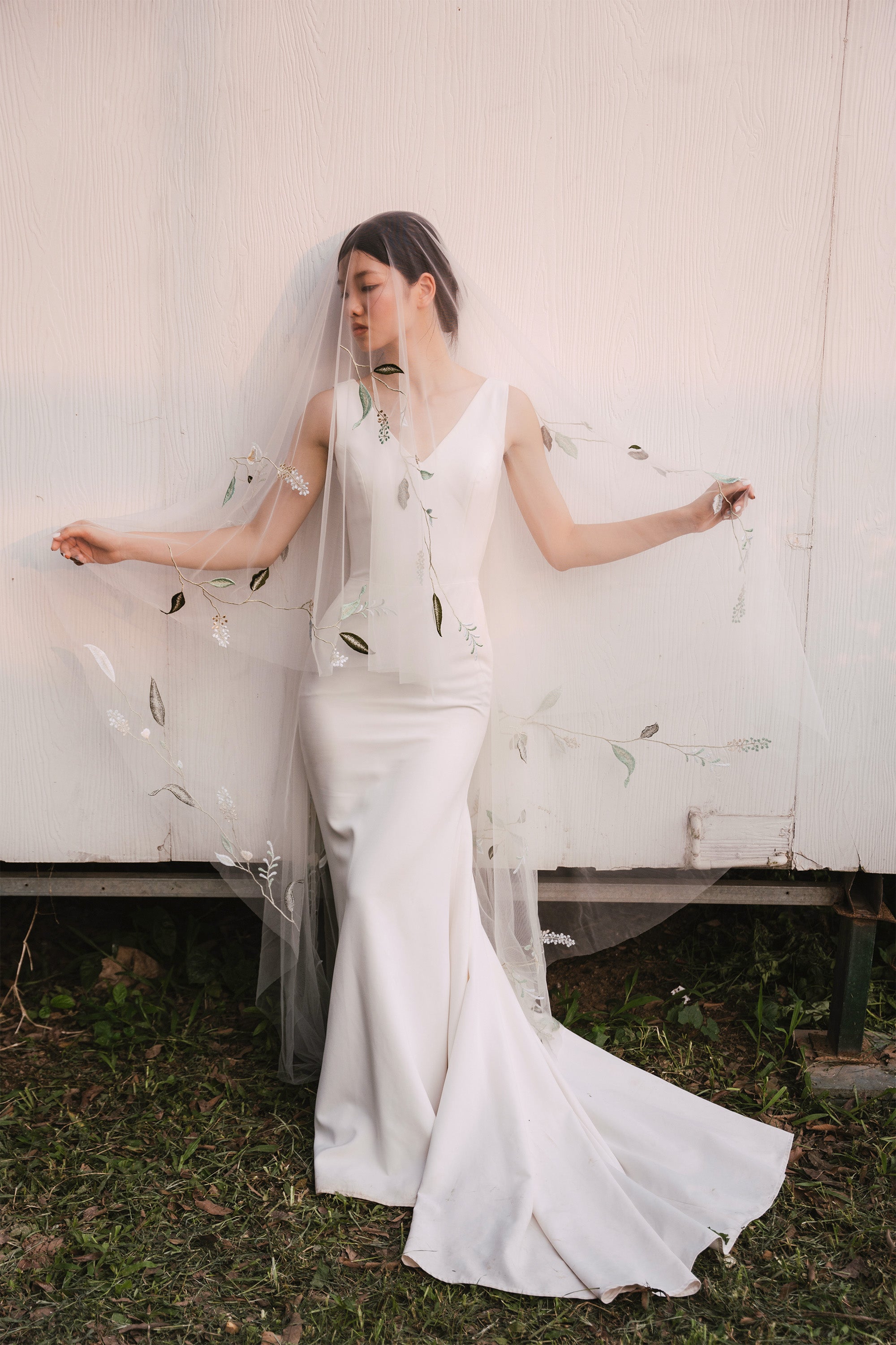 front view of a bride wearing NILSA | Green embroidery floral wedding veil