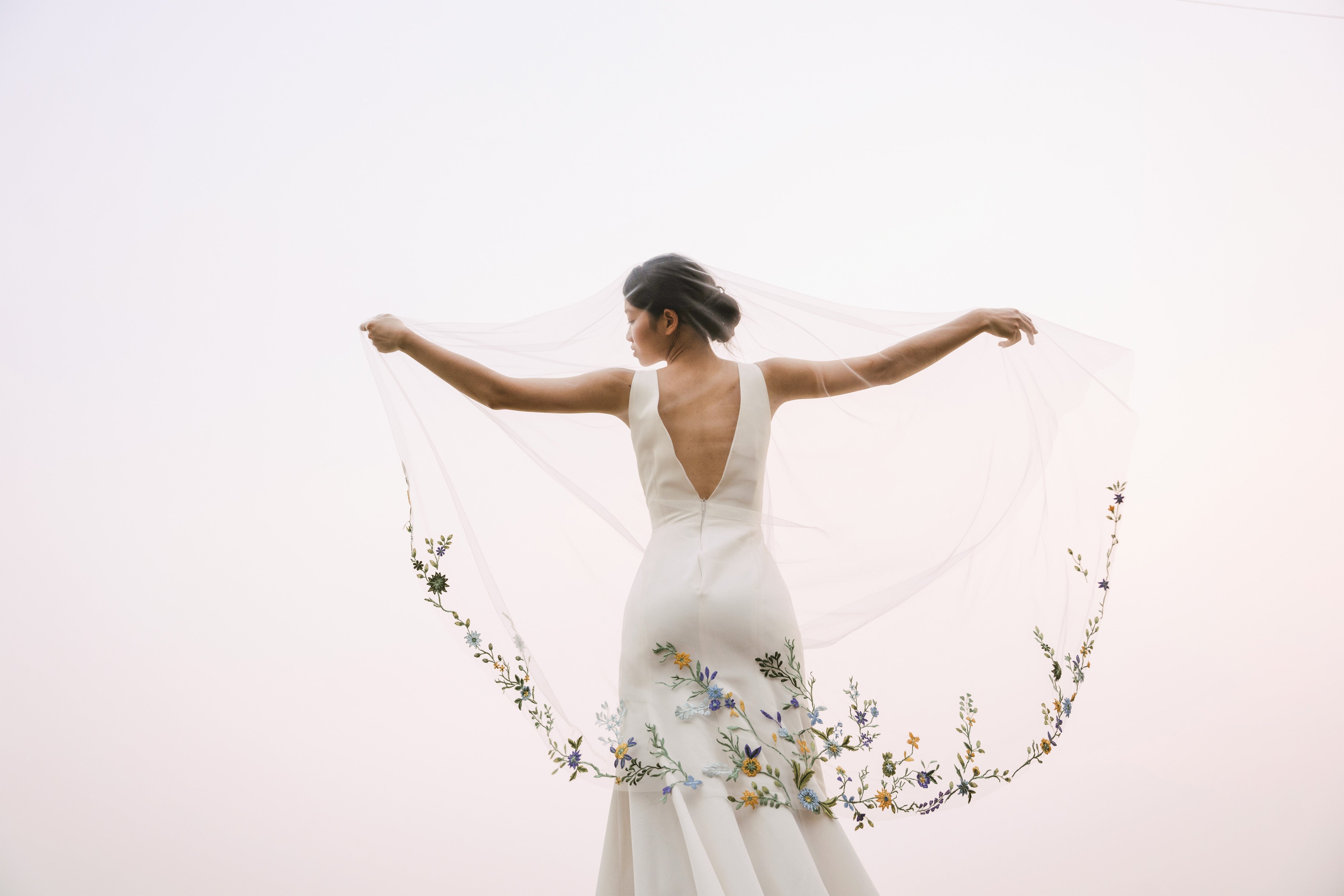 shot from behind of model wearing PAOLA | Colorful floral lace wedding veil