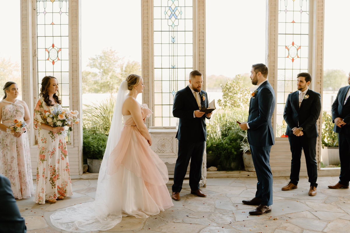 Kait Galligan bride wearing a chapel floral wedding veil and a dreamy pinky wedding dress