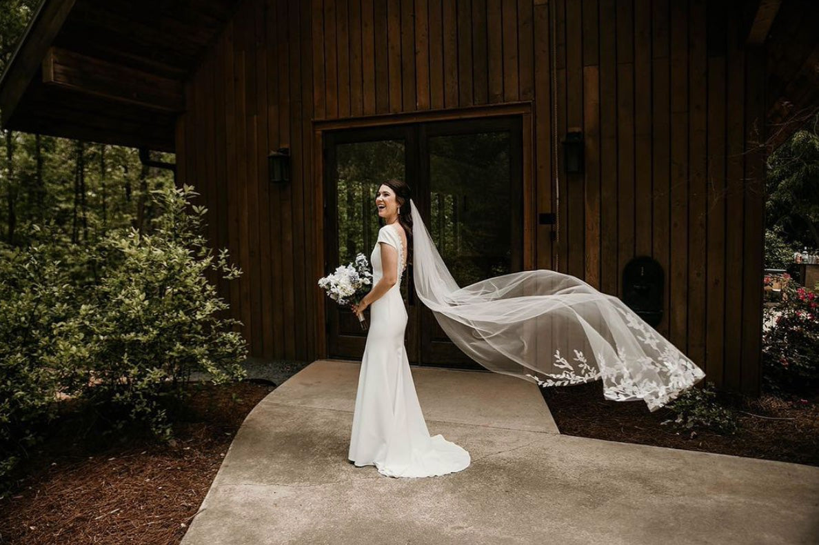 Side profile of bride with Linda chapel floral lace veil
