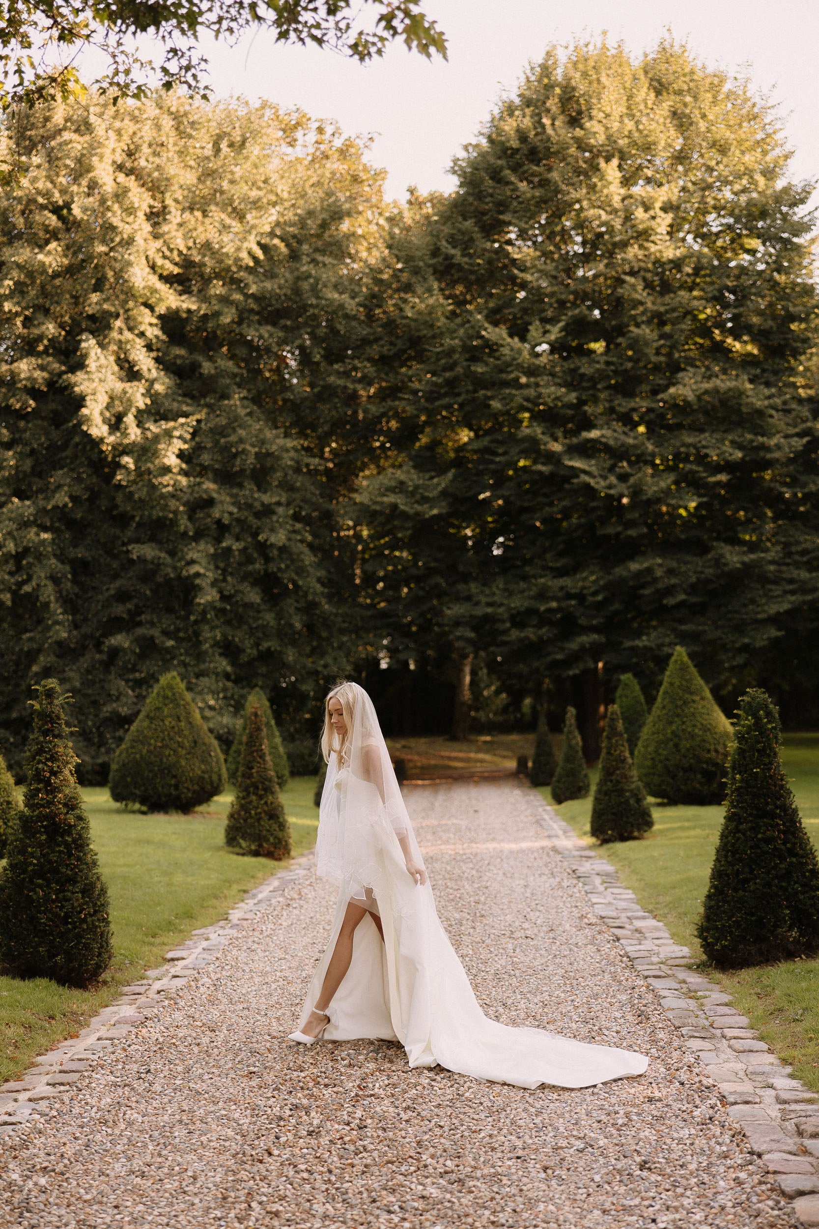 Bride walking down the aisle in Rosie drop chapel organza floral veil