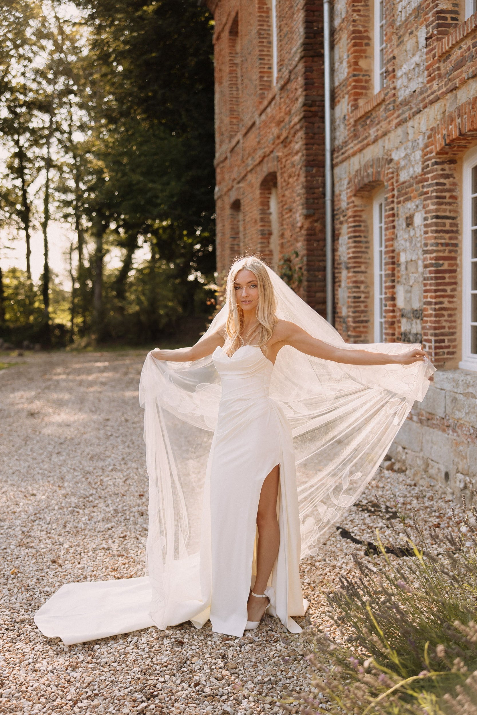Bride wearing Rosie drop chapel organza floral veil front view