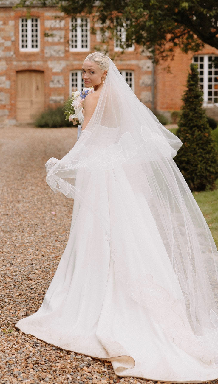 Side profile of bride with Rosie drop chapel floral organza veil