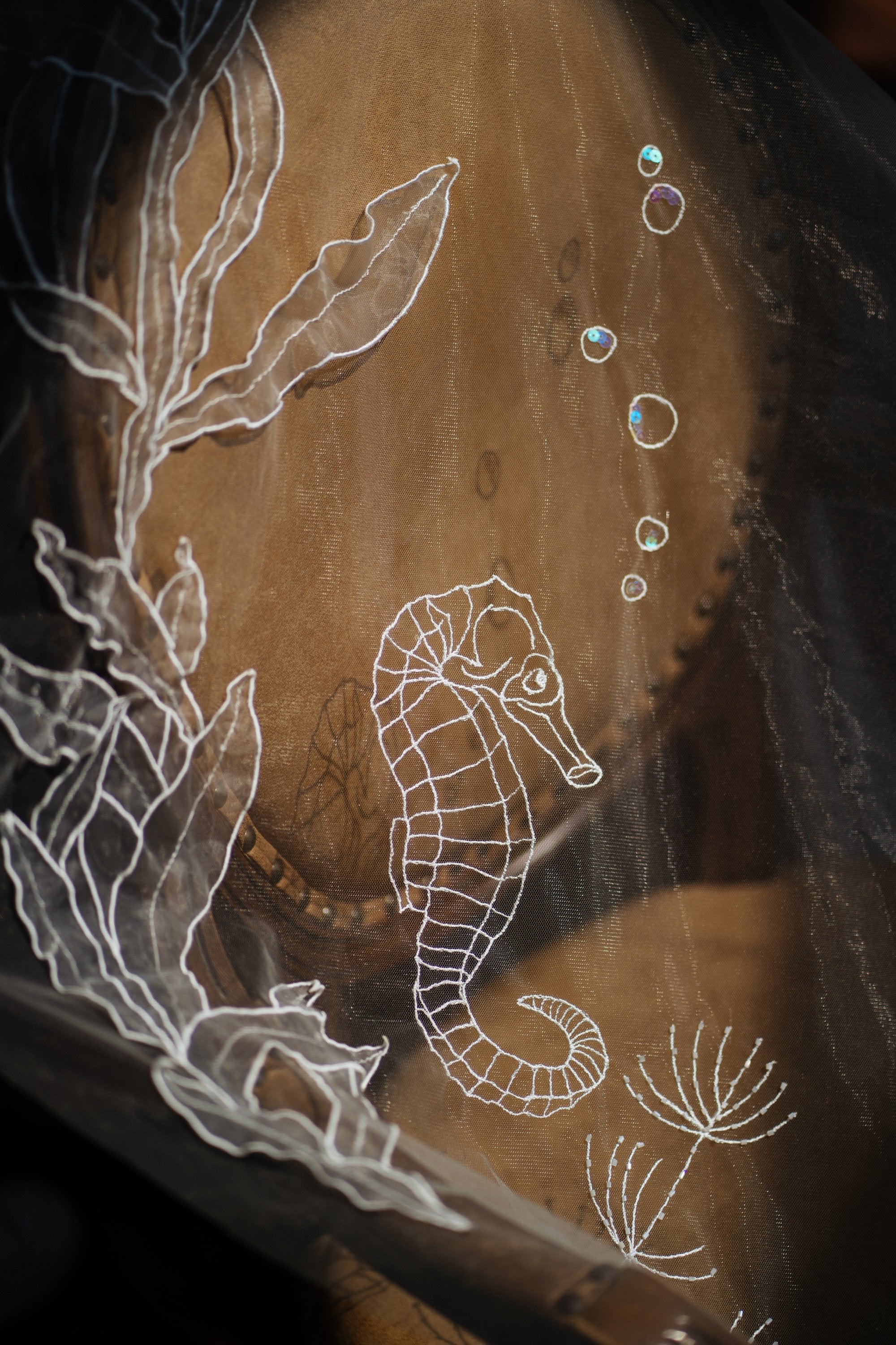 Ocean-inspired wedding veil with 3D embroidered marine life featuring jellyfish, starfish, seahorses, and seaweed on organza fabric, perfect for beach weddings