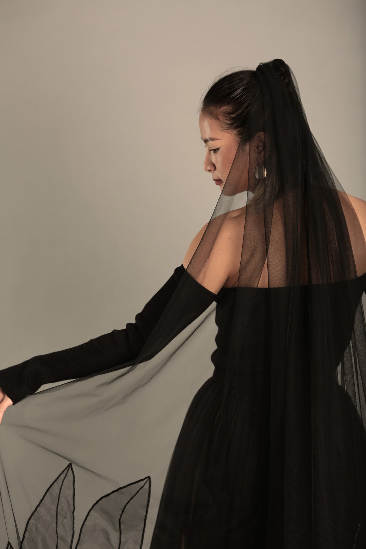 backside image of AUDREY black wedding veil, showcasing its unique style and length.

