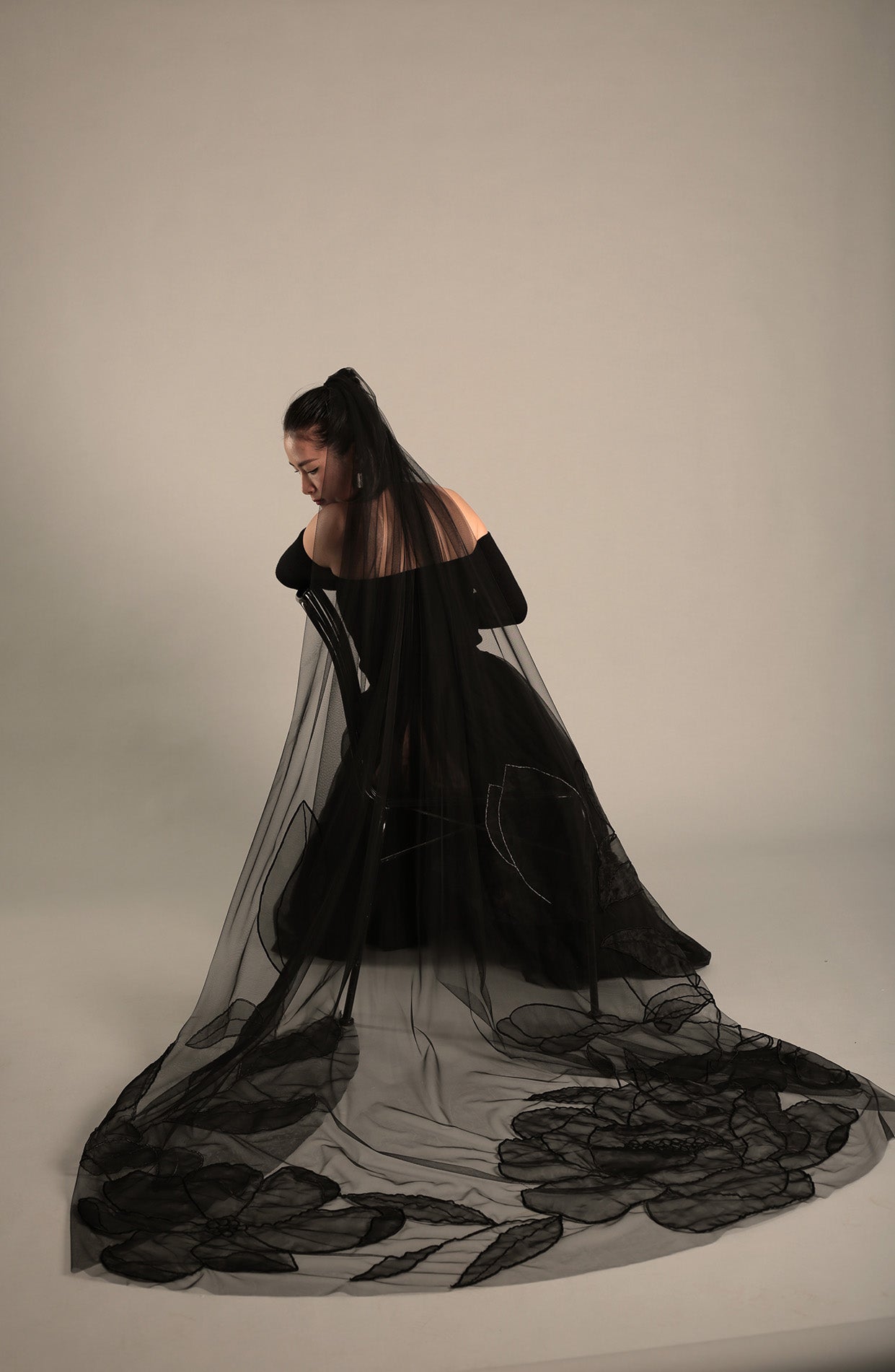 Full shot of the AUDREY black wedding veil, showcasing its unique style and length.

