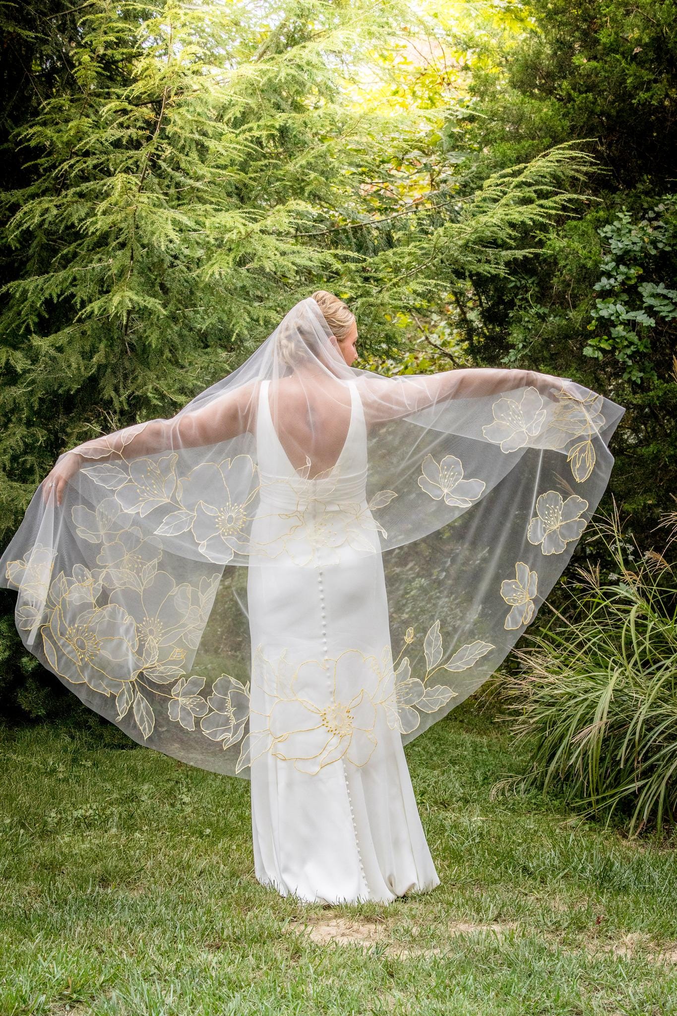 Organza fingertip length wedding veil with blooming vibrant yellow floral motifs, handcrafted by Tara Bridal