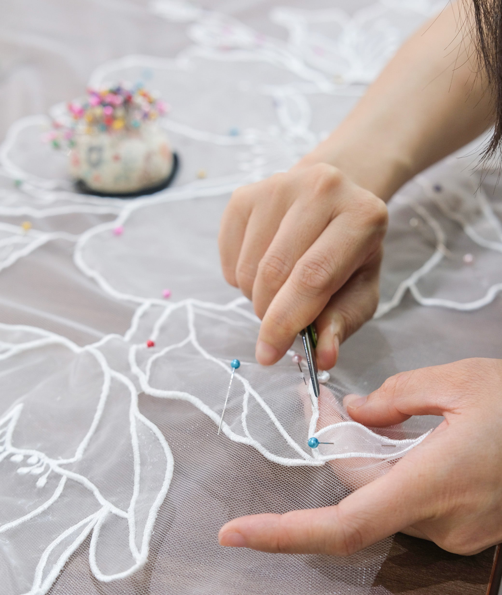 Tara Bridal's artisan hand-crafting every details of a floral veil.